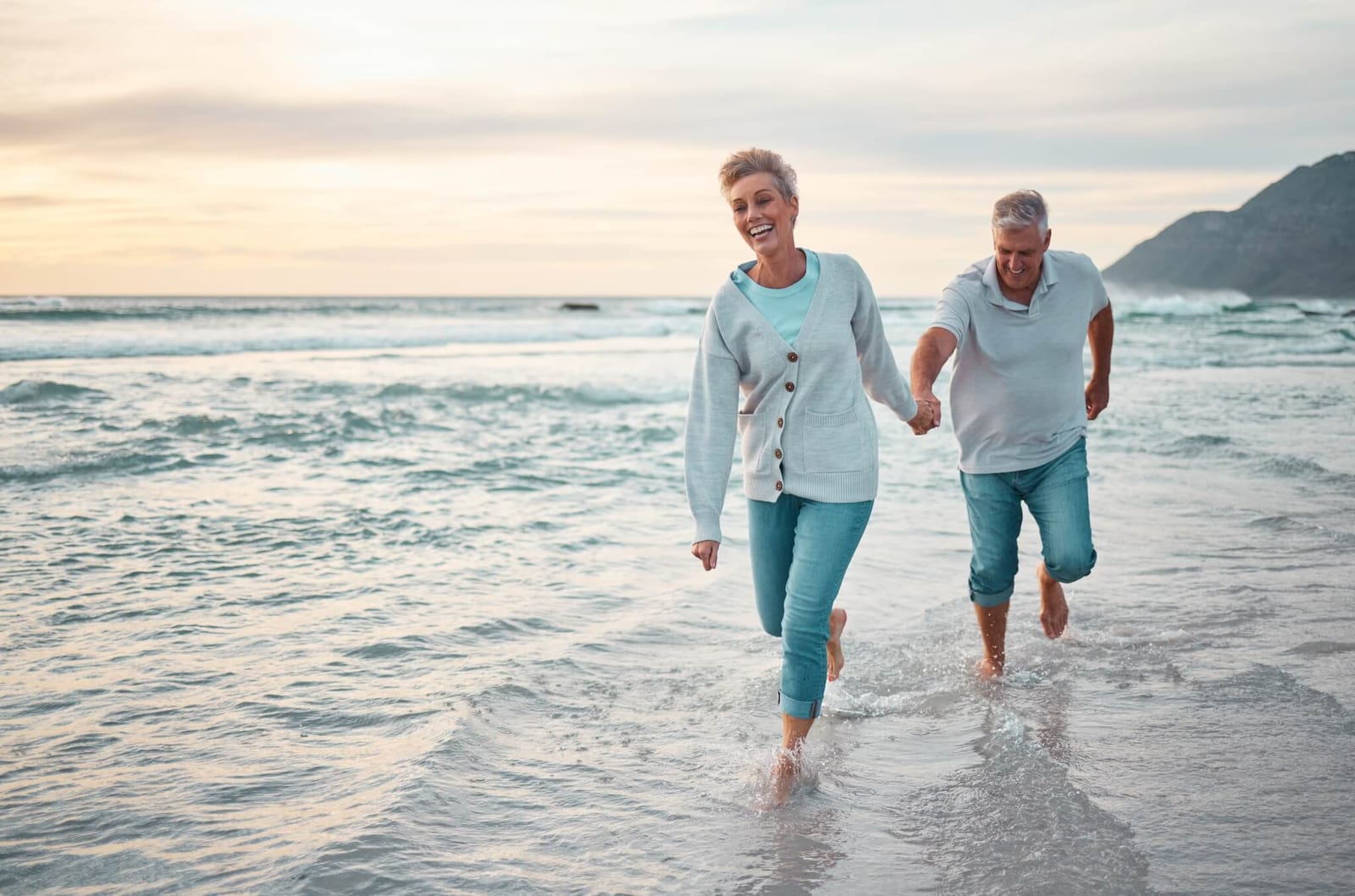 woman leading a man with amnesia along a beach