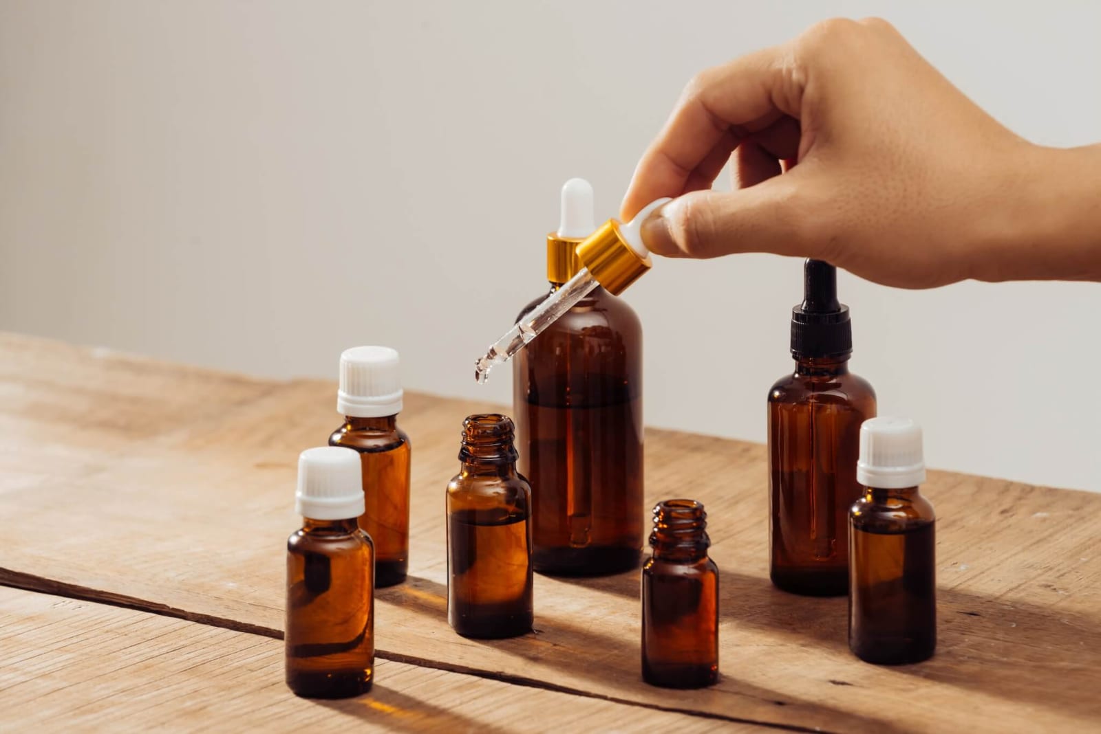 hand using a dropper to create an aromatherapy blend of essential oils to help with nasal and sinus congestion symptoms