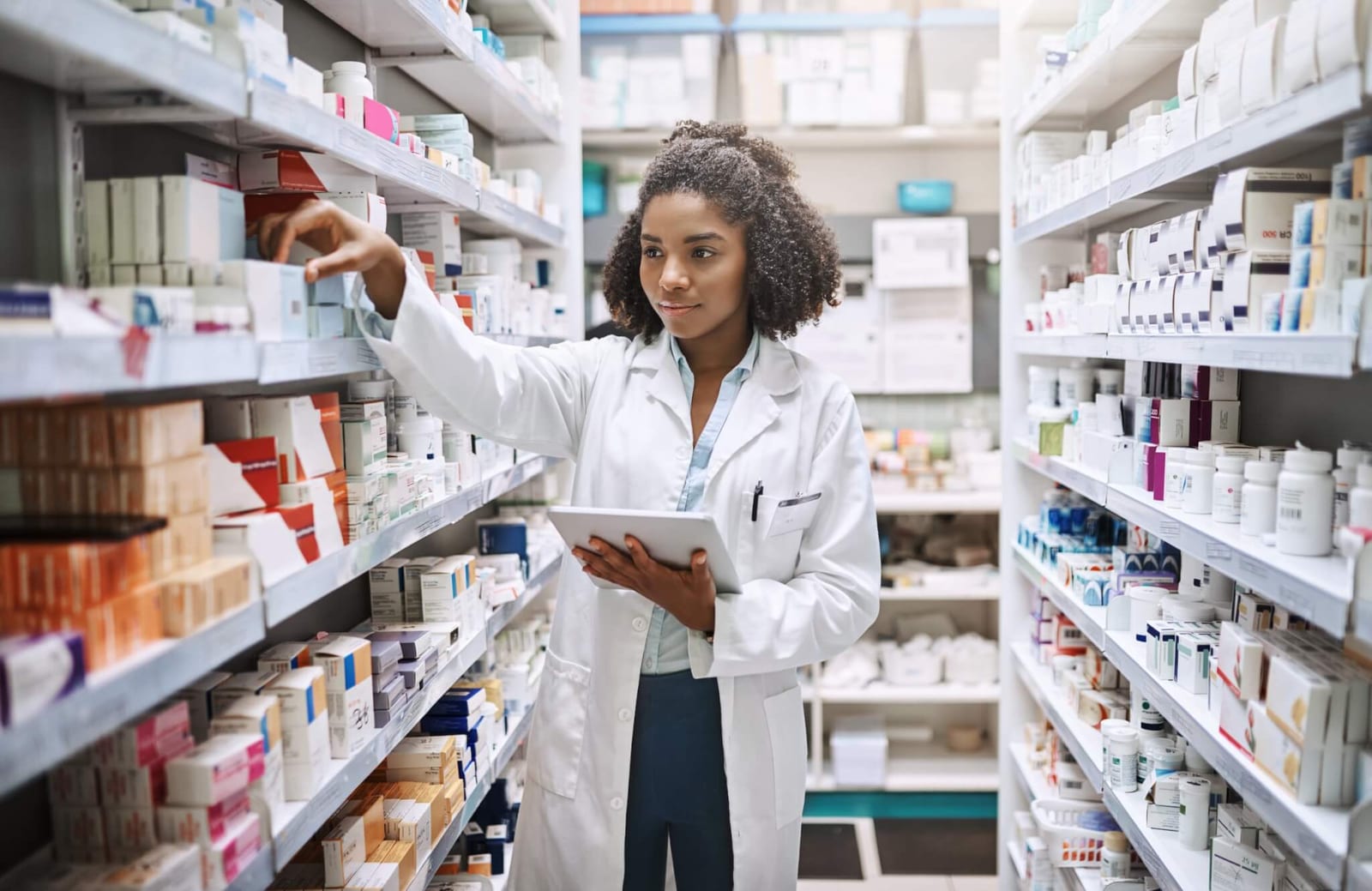 pharmacist looking for an at home colon cancer screening test option on the pharmacy shelves