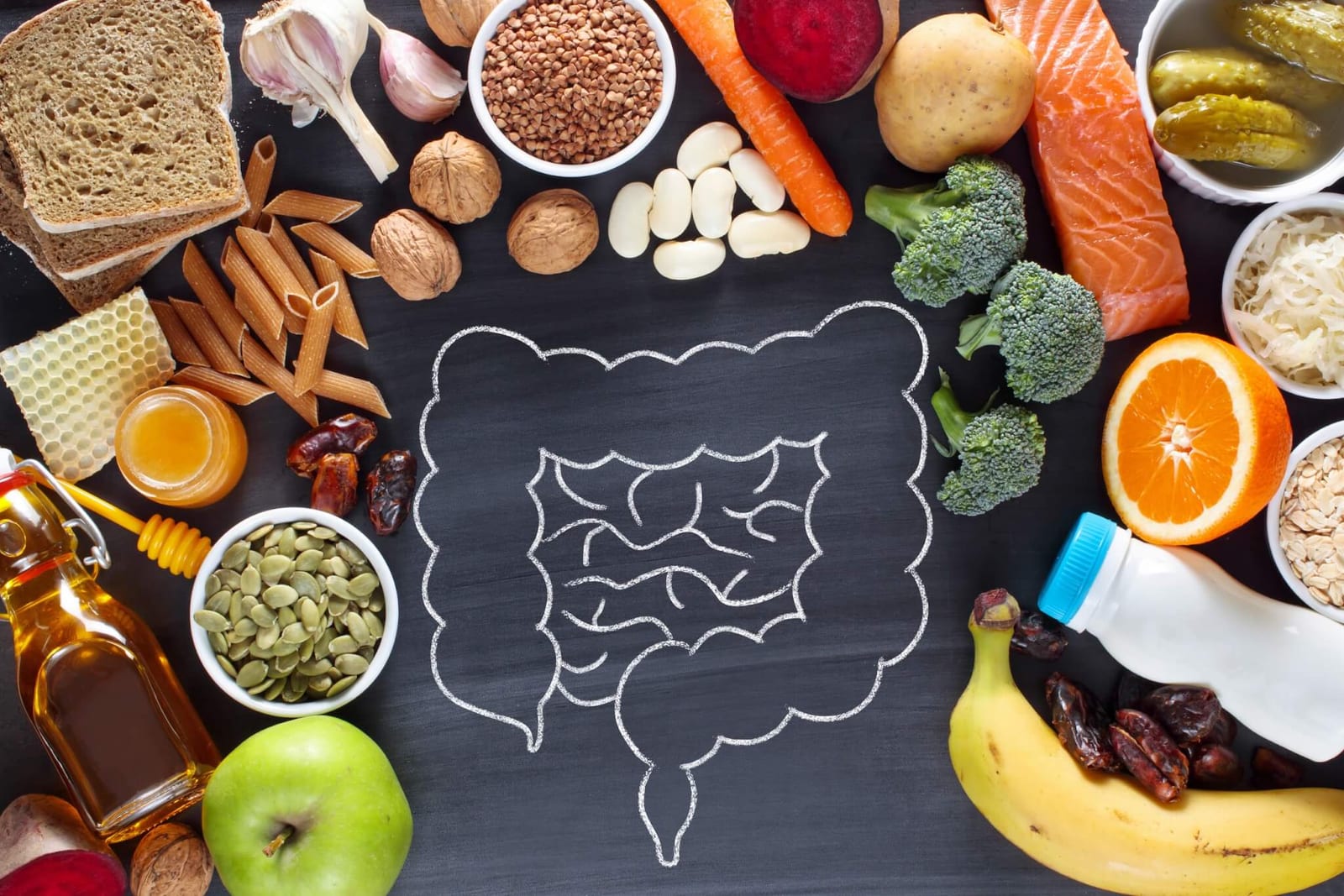 visual of a colon drawn on a chalkboard surrounded by high fiber foods