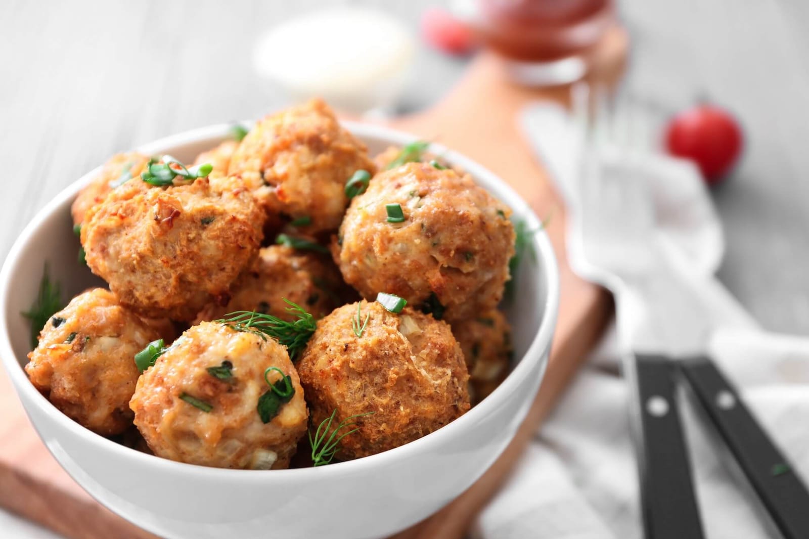 Bowl with delicious turkey meatballs on table
