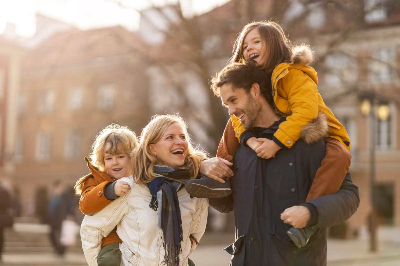 family of four getting out in the sunshine on a fall day so they can experience the anti anxiety mood boosting benefits of natural light therapy