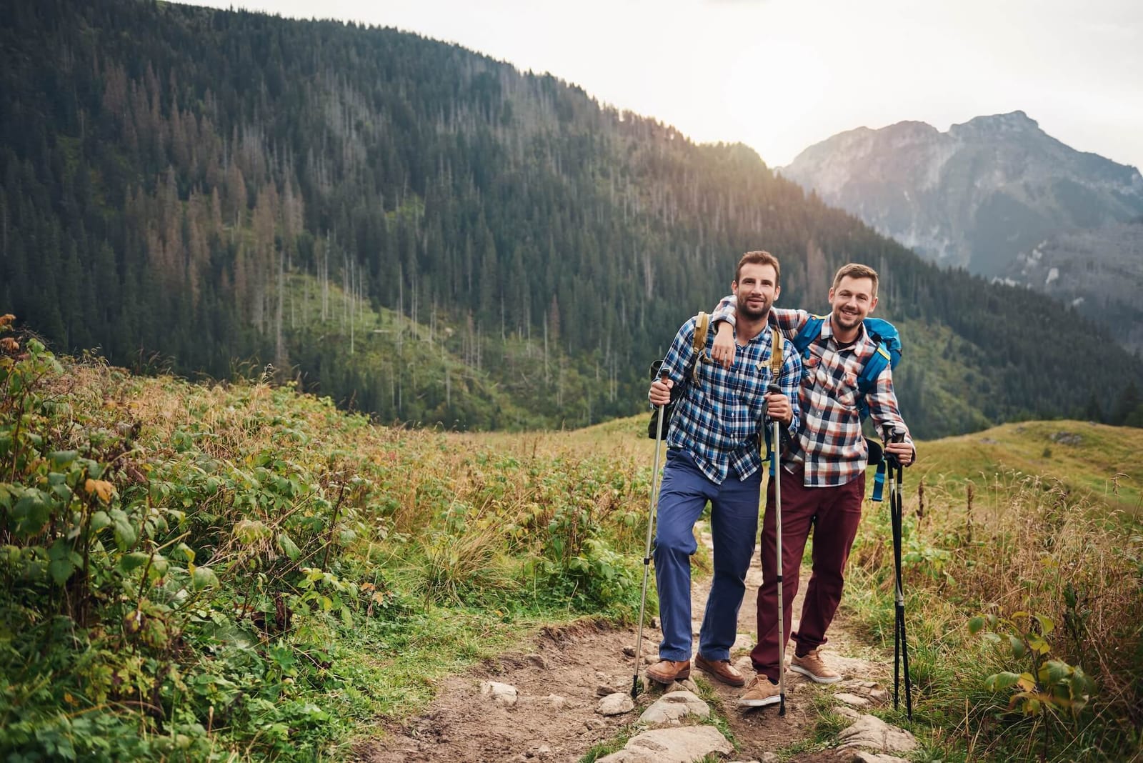 Smiling friends trekking together in the hills men's hormones