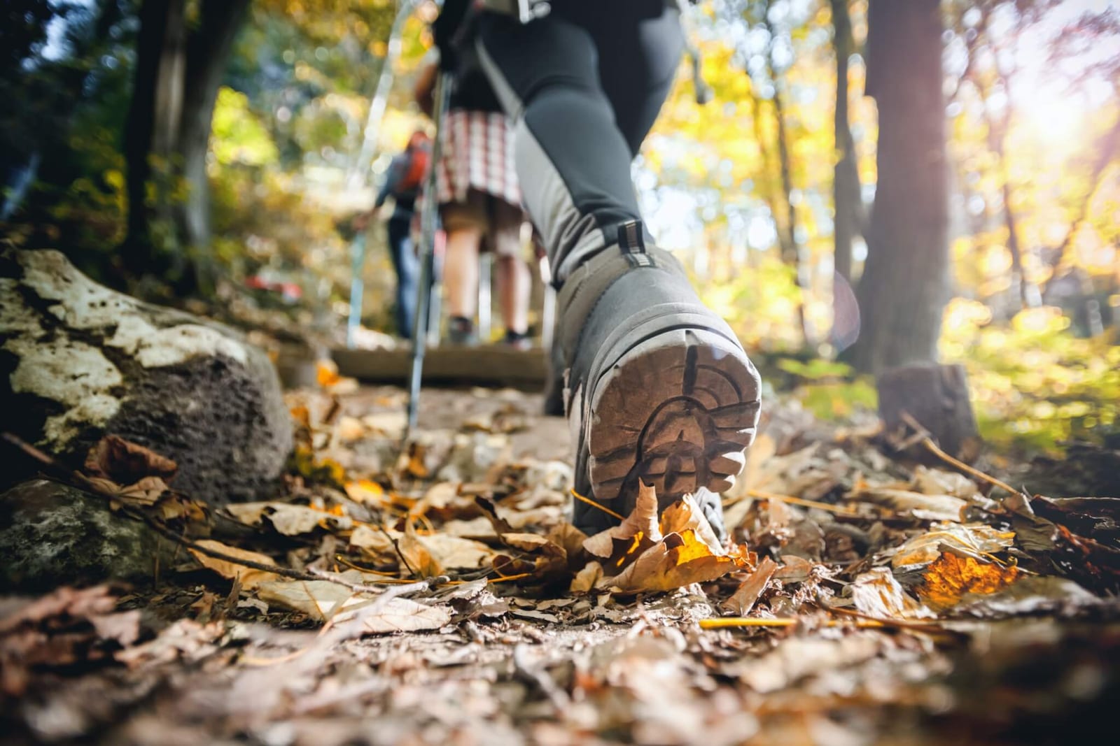 woman wearing properly fitting hiking boots and preventing blisters on her feet on her long hike