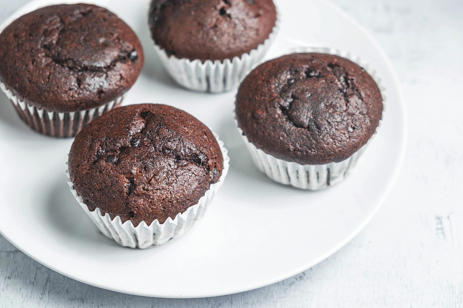 bakery chocolate cupcakes in a dish on a white background Tasty Wintertime Eats (and Treats)