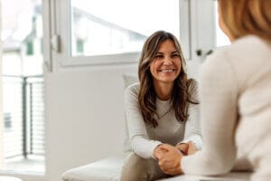 Smiling woman talking to a doctor pelvic floor therapy spotlight